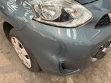 a picture of a car that has been dented and is in a garage