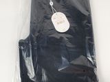 a black shirt in a plastic bag with a tag on it