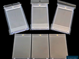 four clear plastic id cards sitting on top of a black surface
