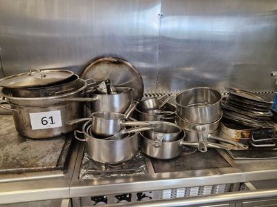 many pots and pans on the stove in the kitchen