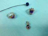 a close up of three different pieces of jewelry on a table