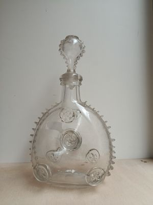 a glass bottle that is sitting on a table