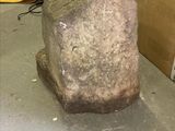 a large rock sitting on the floor in a room
