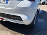 the rear end of a silver car parked in a parking lot