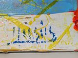 a picture of a painting on a table with a flower on it