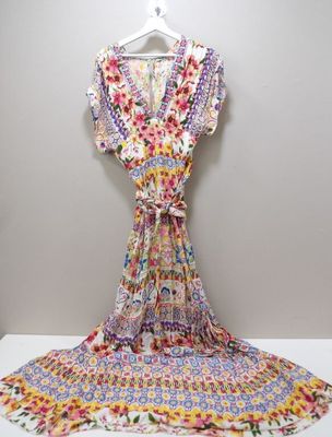 a dress hanging on a hanger on a wall next to a white wall