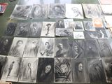 several black and white pictures of people are on a table