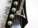 a close up of an electric guitar with a headstock