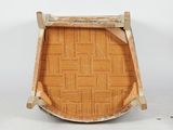 an old wooden chair sitting on top of a floor next to a white wall