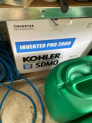 a green container with a blue hose next to a green container with a blue hose
