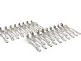 a lot of silver spoons and forks on a white surface