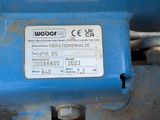 a close up of a blue valve with a label on it