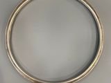silver bangle with a gold band and a white background