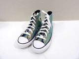 green and white converse sneakers with a cat on them on a white surface