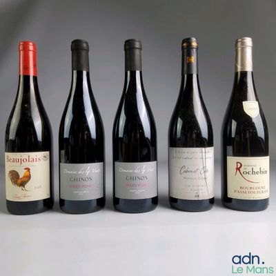 several bottles of wine are lined up on a table