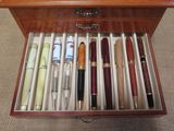 many pens in a wooden box on the floor