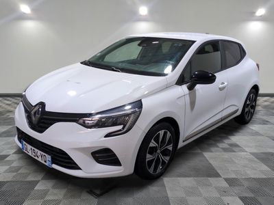 the white car is parked on a checkered floor in a garage