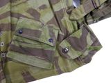 a close up of a camouflage jacket with buttons