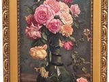 painting of roses in a vase on a table with a gold frame