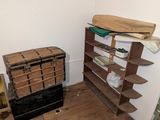 a room that has a shelf and some boxes on the floor