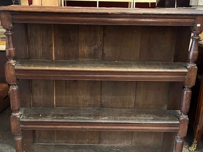 a wooden shelf that has a bunch of shelves on top of it