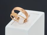 a close up of a gold ring on a white box