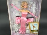 the barbie doll is in a pink box with a picture on it