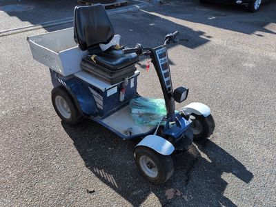 a scooter that is sitting in the parking lot
