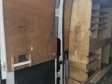 a white van with a wooden door and shelves in the back