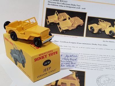 a yellow toy truck sitting on top of a box