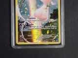 a pokemon card in a plastic case on a table