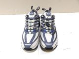 pair of blue and white running shoes on a white surface
