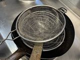 a frying pan on the stove with a wooden handle
