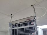a heater hanging from the ceiling in a room