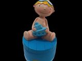 a baby sitting on top of a blue box with a toy boat