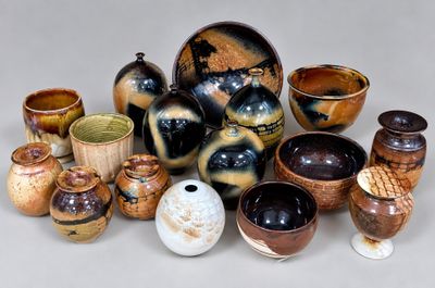 many different types of vases and bowls on the table