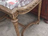 a table with a marble top on it in front of a cabinet
