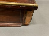 a small wooden table with a clock on top of it