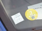 a sticker on the windshield of a car with a sticker attached to it