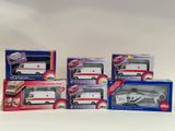 four boxed boxes of toy ambulances on a white surface