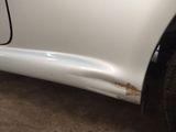 a close up of a car with a denting on the side of it