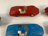 several toy cars are lined up on a white surface