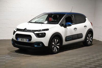 the white citrole is parked in a garage with a checkered floor