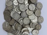 a pile of silver coins sitting on a white surface