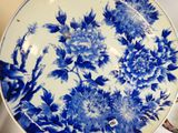 a blue and white plate with flowers on it