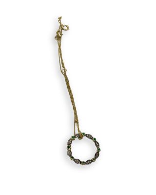 Collier en laiton plaqué, orné de perles vertes et noires sur fond blanc