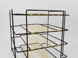 a black metal wine rack with yellow handles on a white background