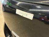 a sticker on the bumper of a car that is parked in a garage