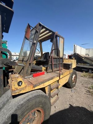 a fork truck that is parked in the dirt