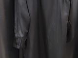 black shirt hanging on a clothes rack in a clothing store